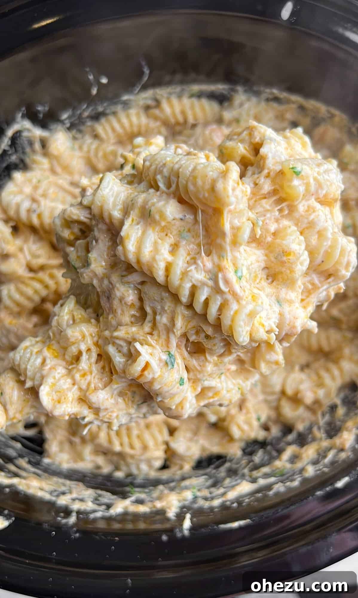 Viral Slow Cooker Chicken Pasta with Olive Garden Dressing 8 Overhead shot of creamy chicken pasta with Olive Garden dressing in a serving bowl