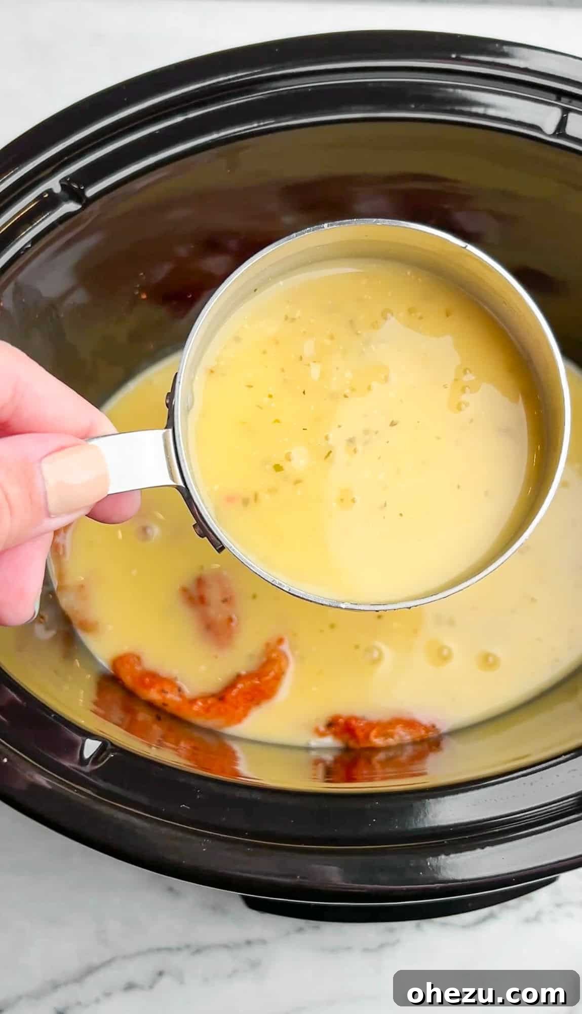 Viral Slow Cooker Chicken Pasta with Olive Garden Dressing 4 Ingredients being added to a slow cooker for chicken pasta
