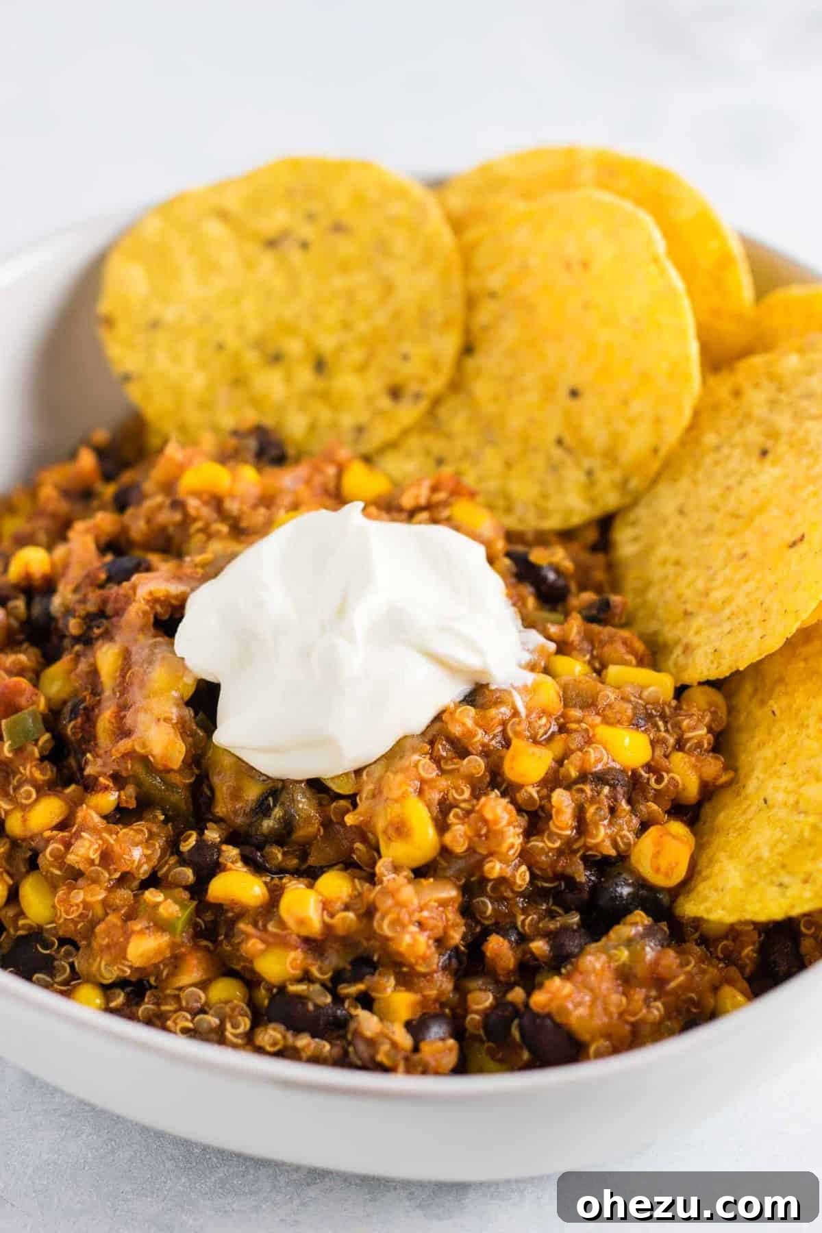A large, steaming Mexican Quinoa Enchilada Bake, topped with melted cheese and fresh cilantro, served in a casserole dish.