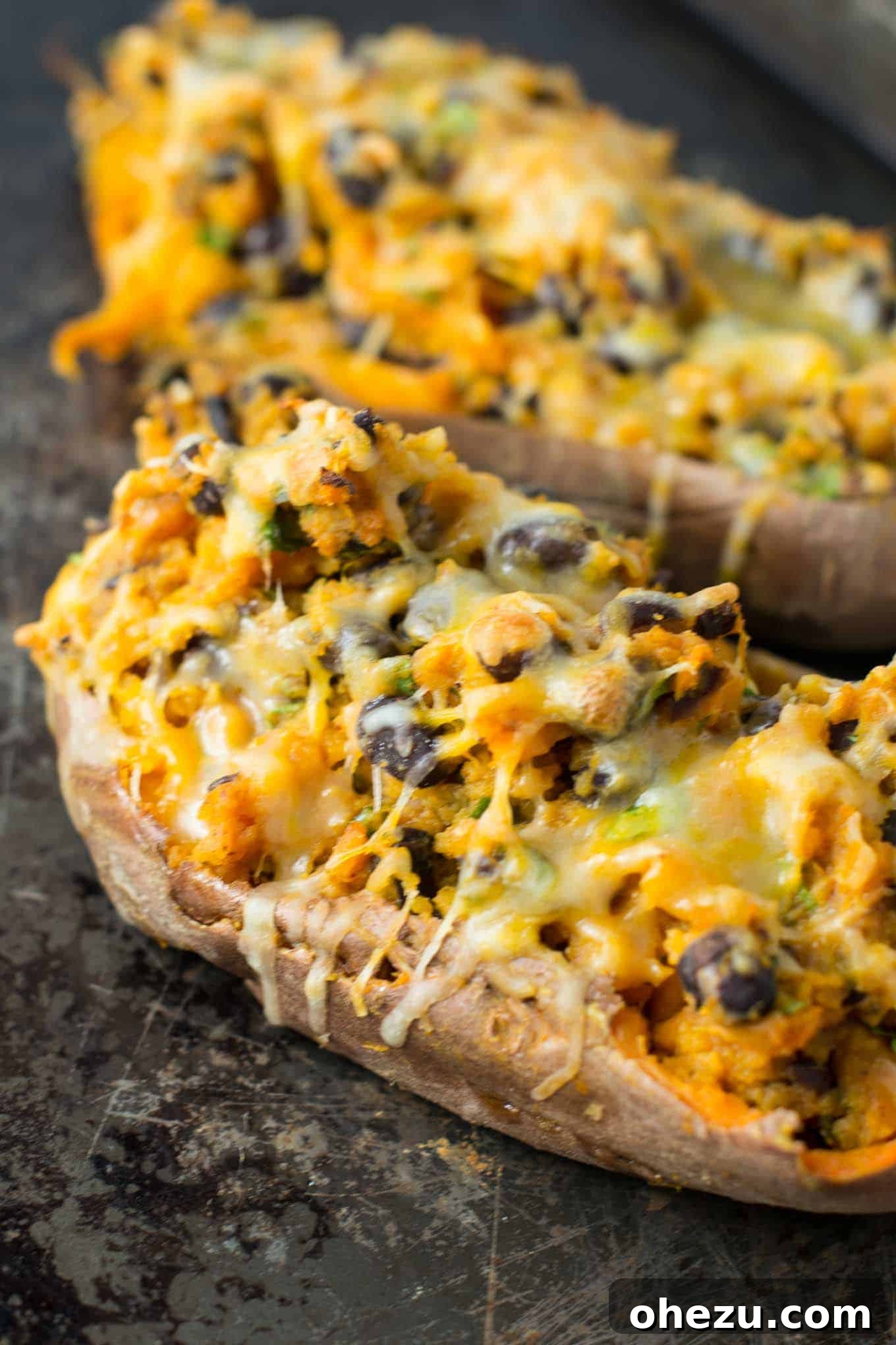 Delicious Mexican Stuffed Sweet Potatoes, halved and generously filled with a vibrant, seasoned vegetarian mixture and fresh toppings.