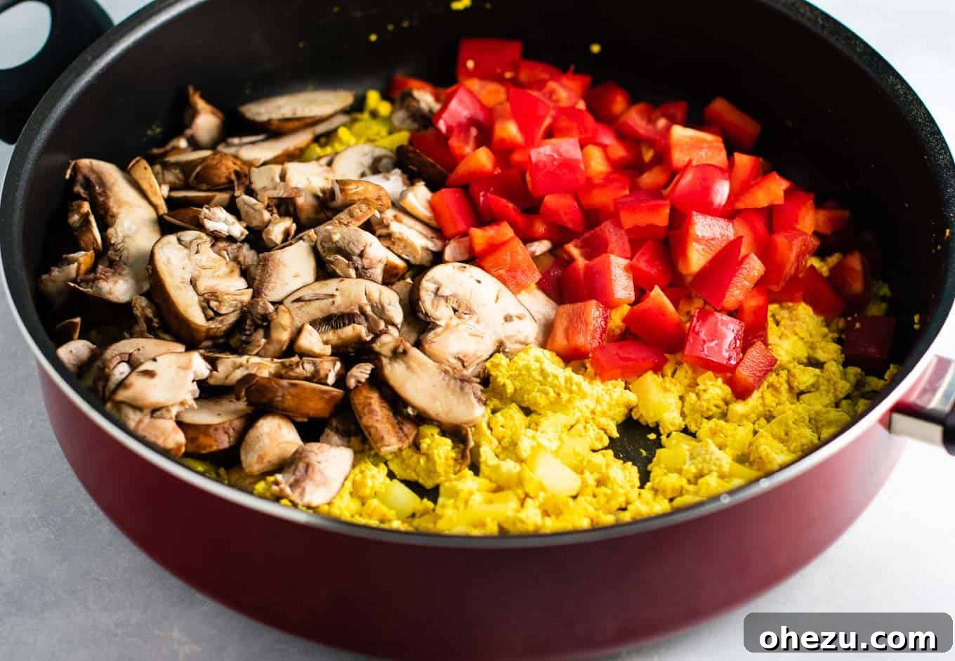 Adding sliced baby bella mushrooms and diced red bell pepper to tofu scramble. A hearty addition to this #meatless #breakfast.
