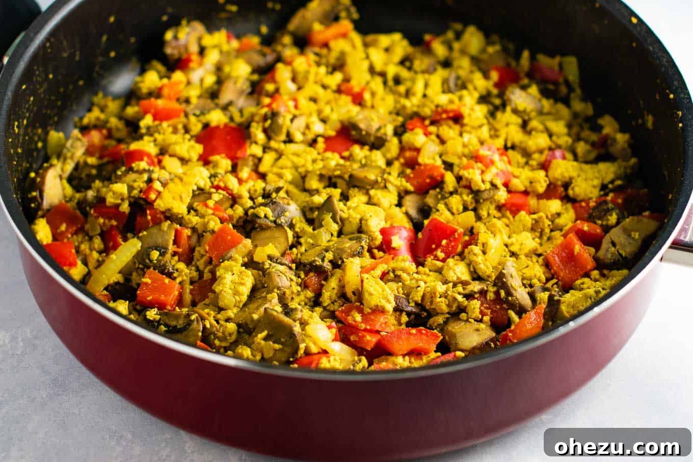 Hearty and flavorful tofu scrambled eggs with bell pepper and mushroom. A highly satisfying #vegan #breakfast that's #eggfree and #dairyfree.