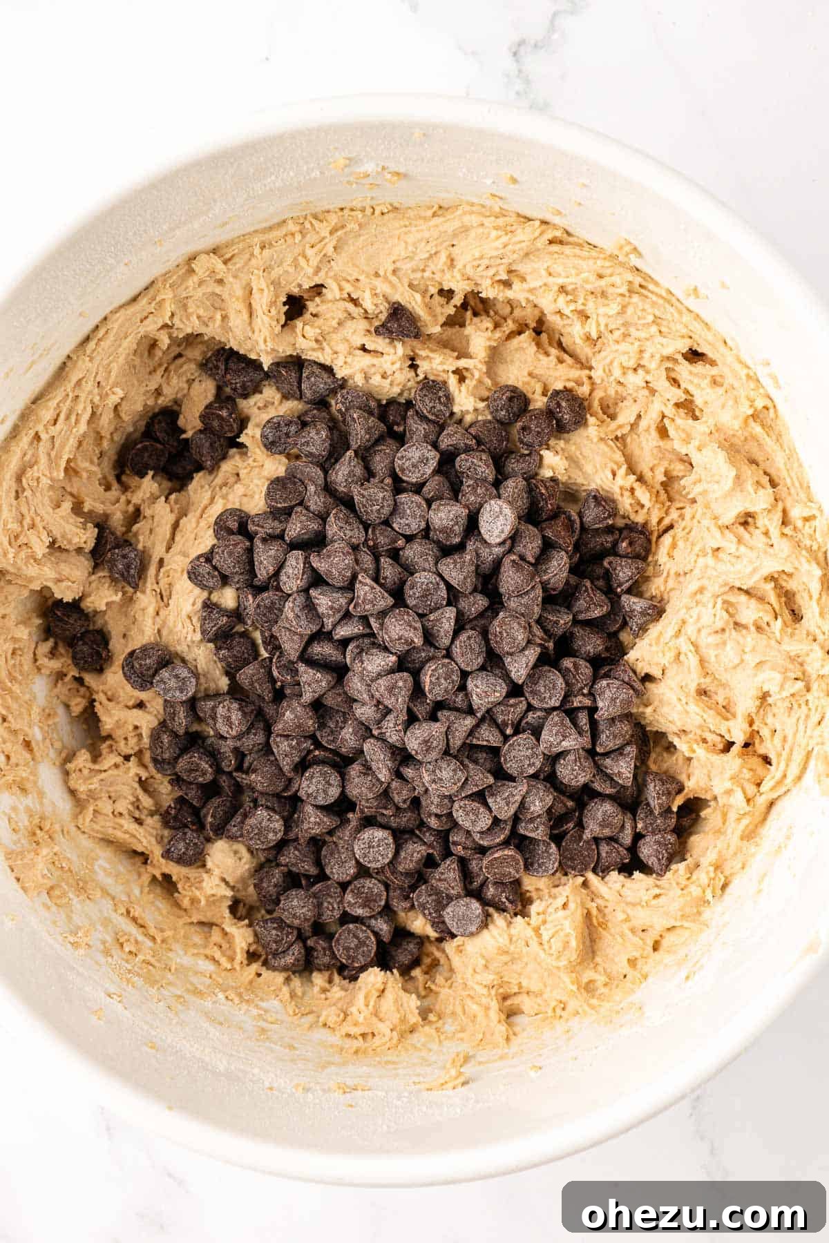 Heavenly Vegan Chocolate Chip Cookies 11 Dairy-free chocolate chips being added to the prepared vegan cookie dough batter.