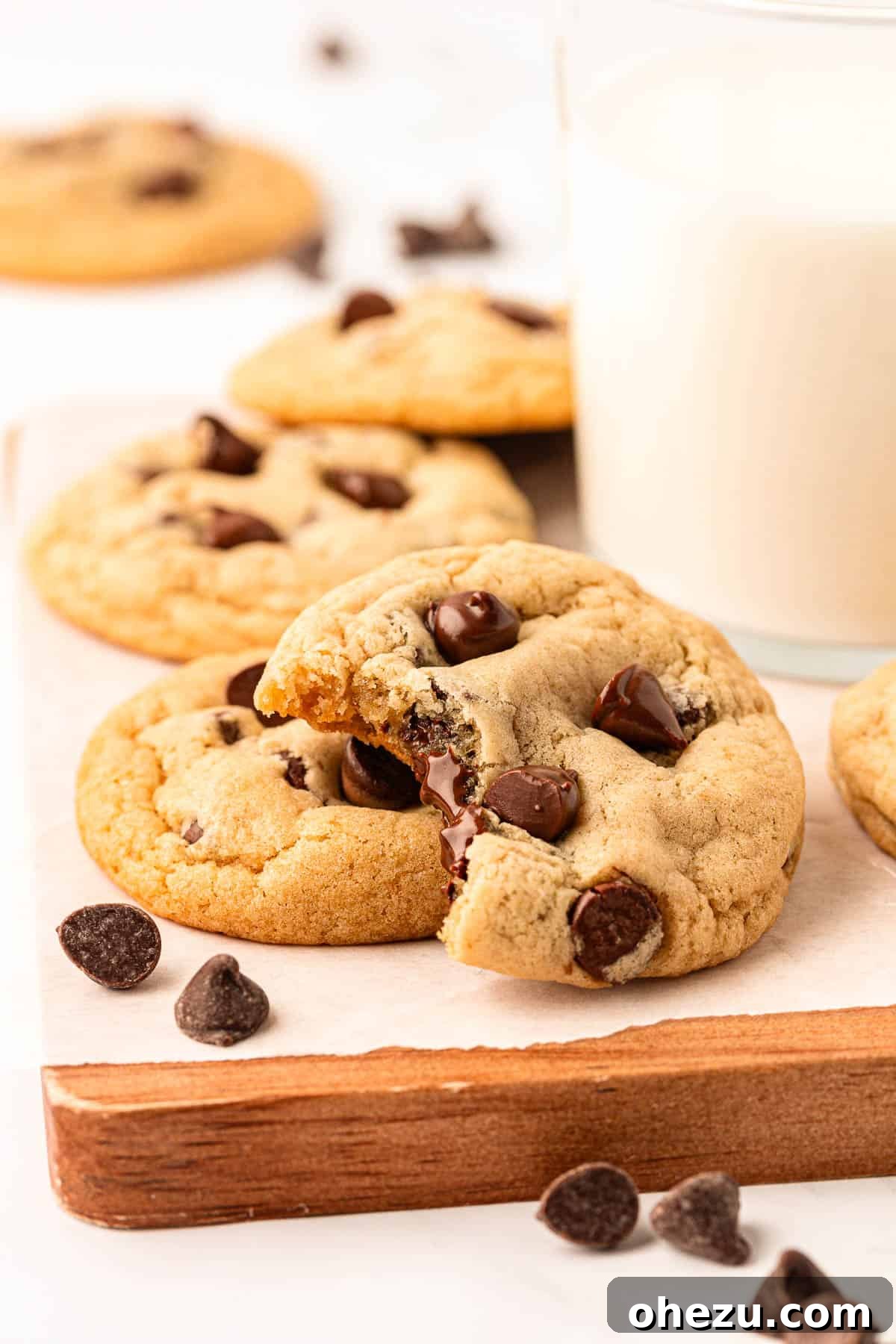 Heavenly Vegan Chocolate Chip Cookies 18 A close-up of a perfectly baked vegan chocolate chip cookie broken in half, revealing its soft, chewy interior and gooey chocolate.