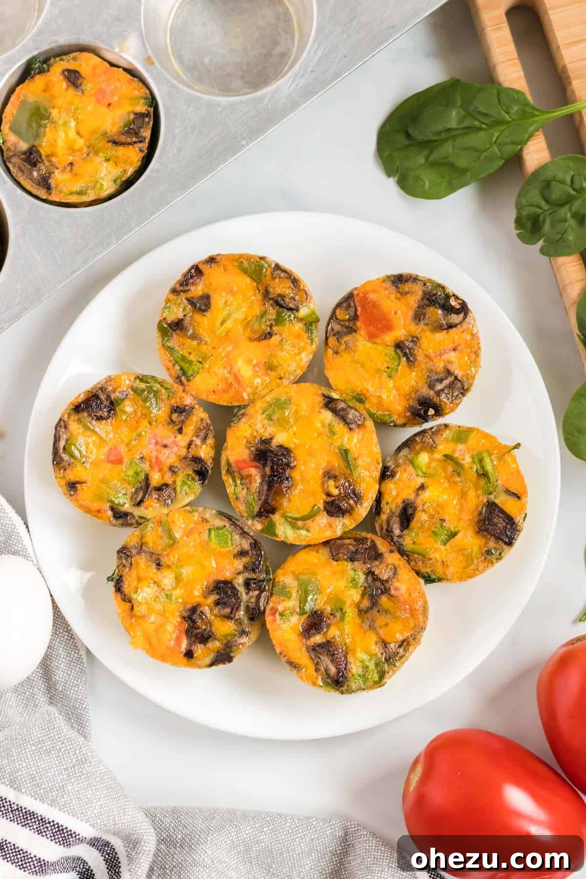 Delicious egg muffin cups beautifully arranged on a white plate, ready to be enjoyed as a healthy breakfast.