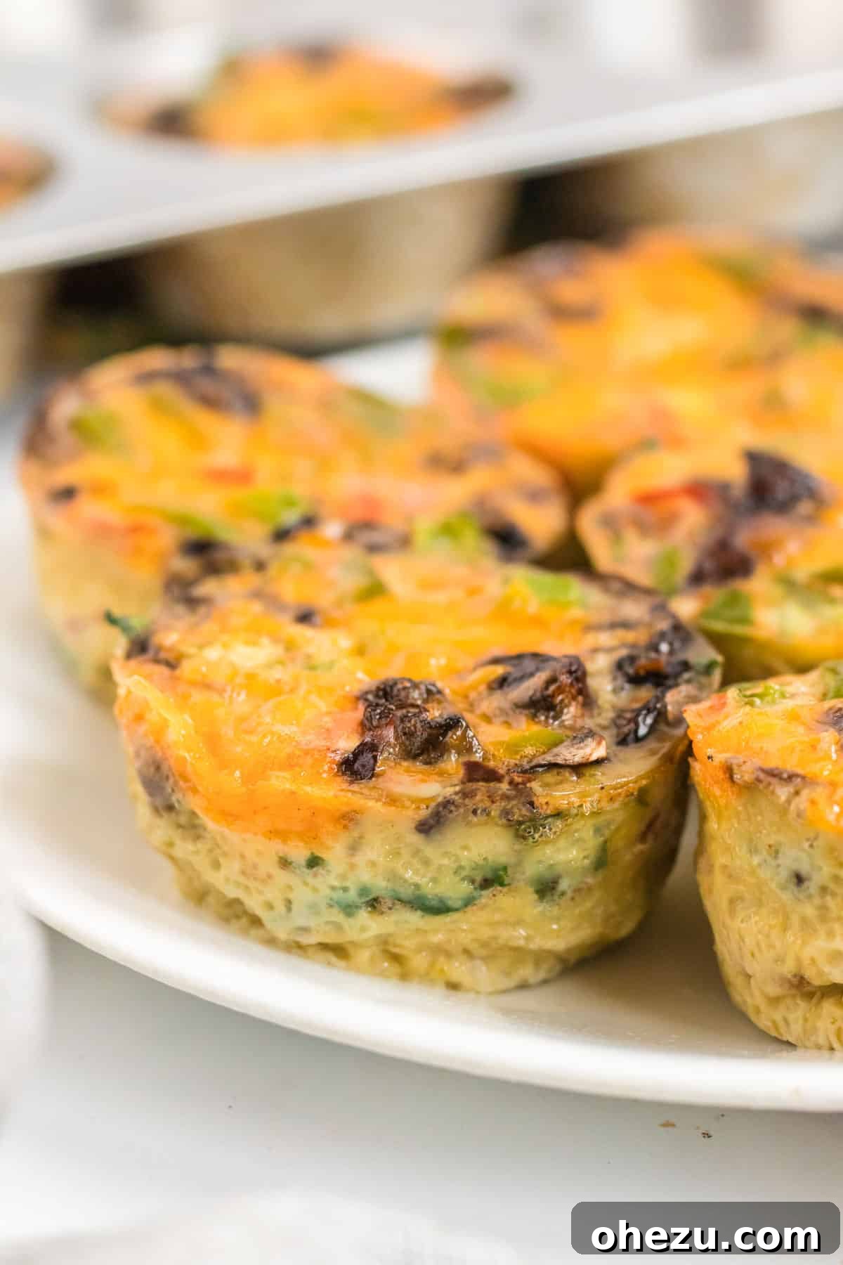 A plate of fluffy, golden egg muffins, highlighting their appetizing texture and wholesome appearance.