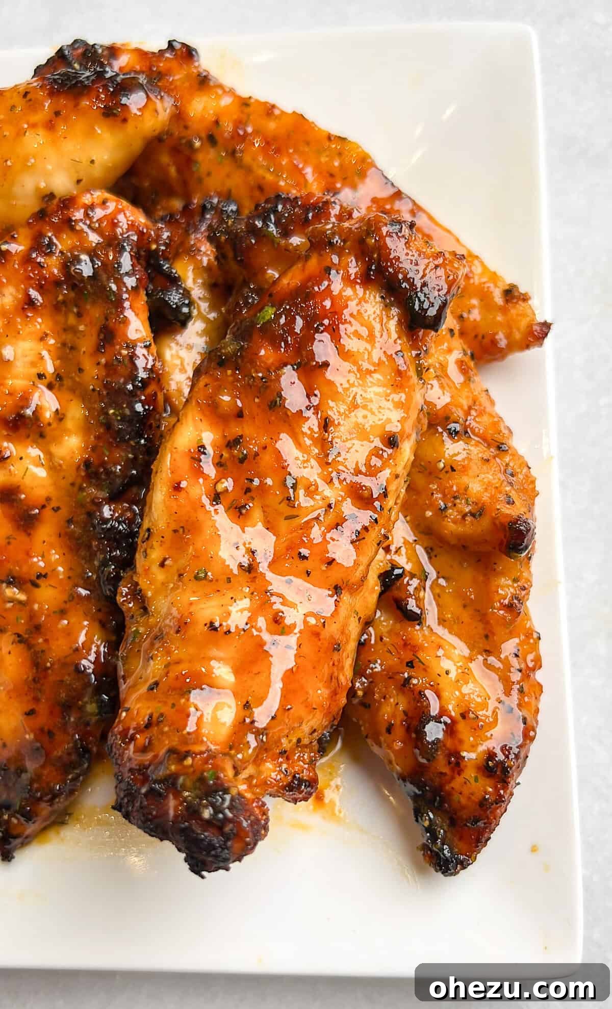 Air-Fried Hot Lemon Pepper Ranch Chicken Tenders 2 Deliciously glazed Hot Lemon Pepper Ranch Air Fried Chicken Tenders served on a platter, ready to eat.