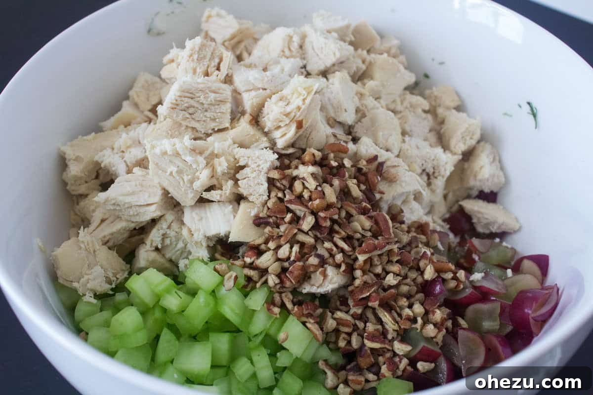 Wholesome and Satisfying Chunky Chicken Salad 4 A pristine bowl of the creamy Greek yogurt and fresh dill dressing, highlighting the vibrant green herbs and smooth, luscious texture, poised for combination with the chicken.