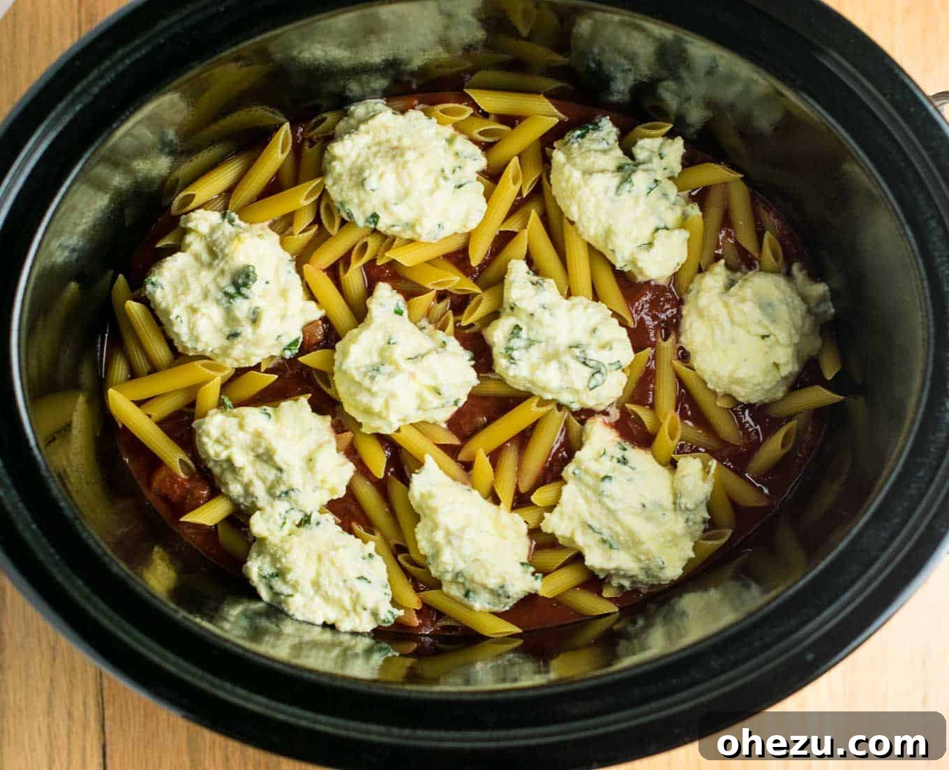 This Easy Crockpot Baked Ziti gets RAVE reviews. Everyone loves this when I make it! So simple to assemble and you don’t even have to cook the noodles first! #crockpotbakedziti #ziti #pasta #slowcooker