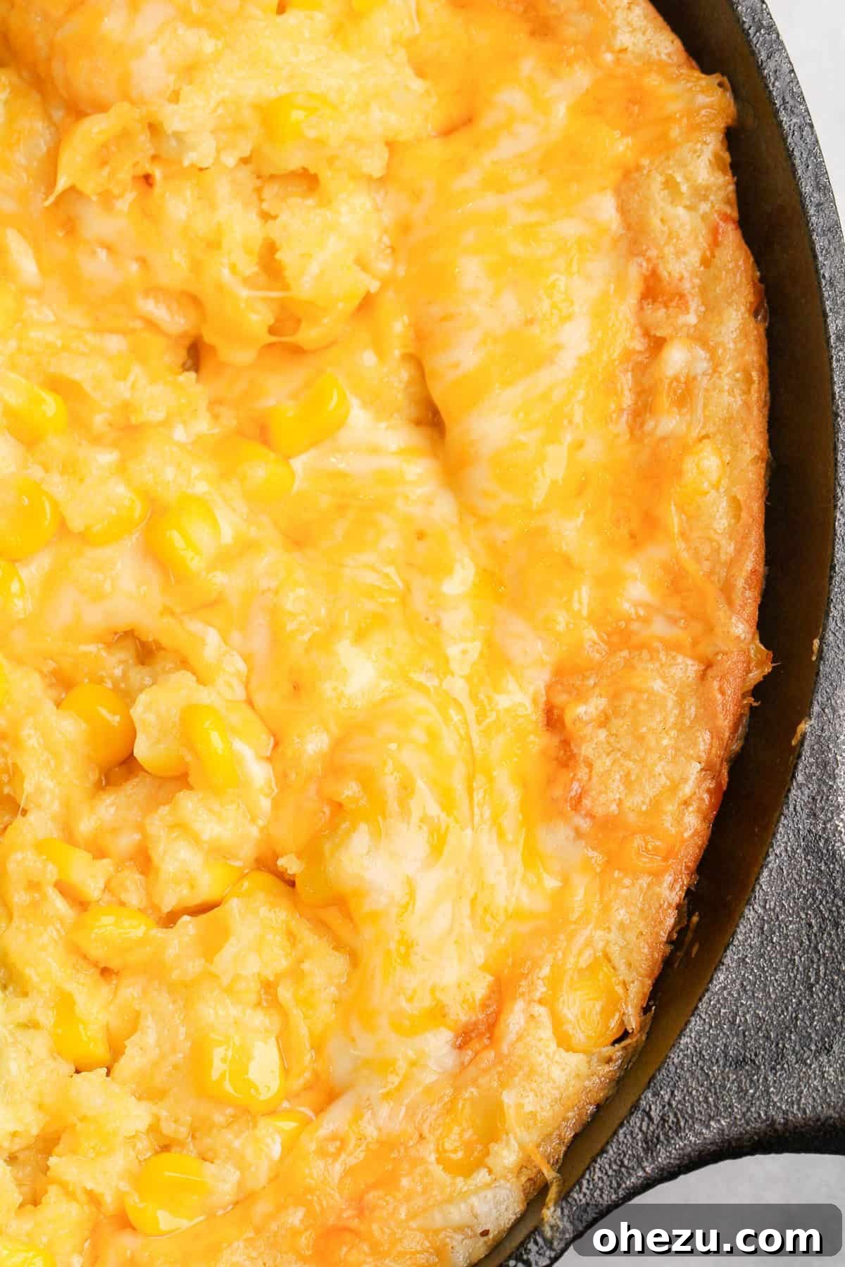 Golden Cheesy Corn Bake 6 Jiffy Corn Casserole served on a table with other dishes.