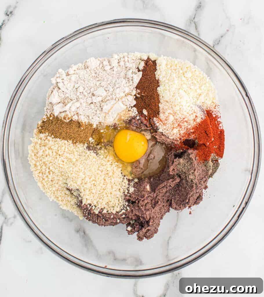 Adding all the black bean burger ingredients into a mixing bowl, including spices and binders.