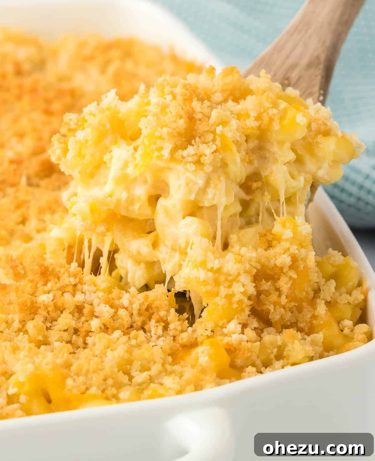 scooping mac and cheese from the baking dish