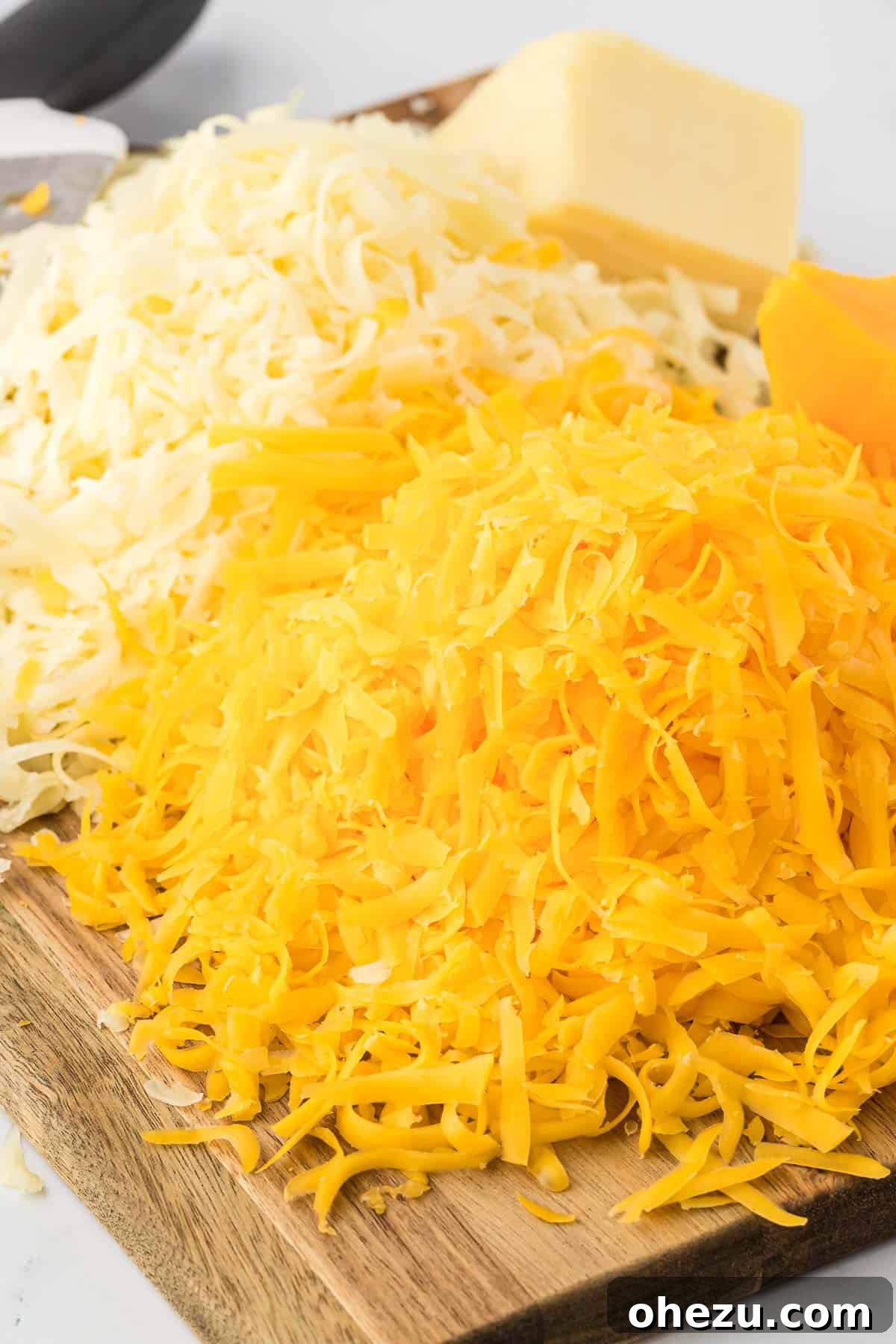 freshly grated cheese on a cutting board