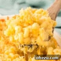scooping mac and cheese from the baking dish