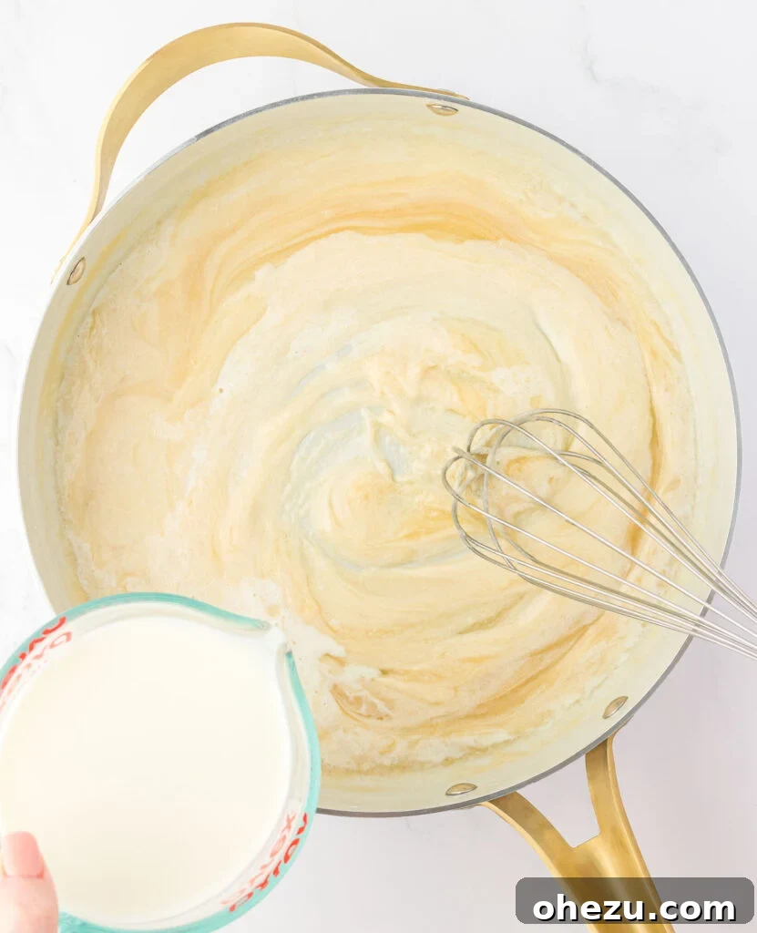 adding milk to the roux