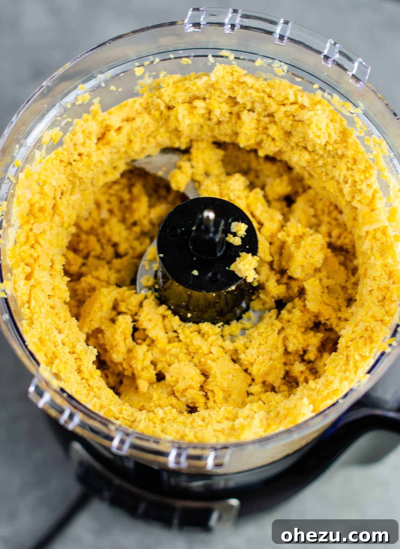 Golden Chickpea Bites 5 Finely processed chickpeas with a flaky texture in a food processor, demonstrating the ideal consistency for chickpea nuggets.