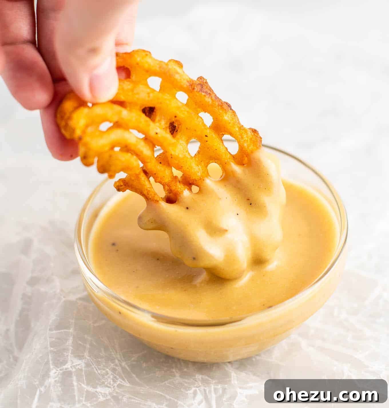 Golden Chickpea Bites 8 Crispy waffle fries and a chickpea nugget generously dipped in creamy Chick-fil-A style sauce, showcasing a perfect vegan meal idea.