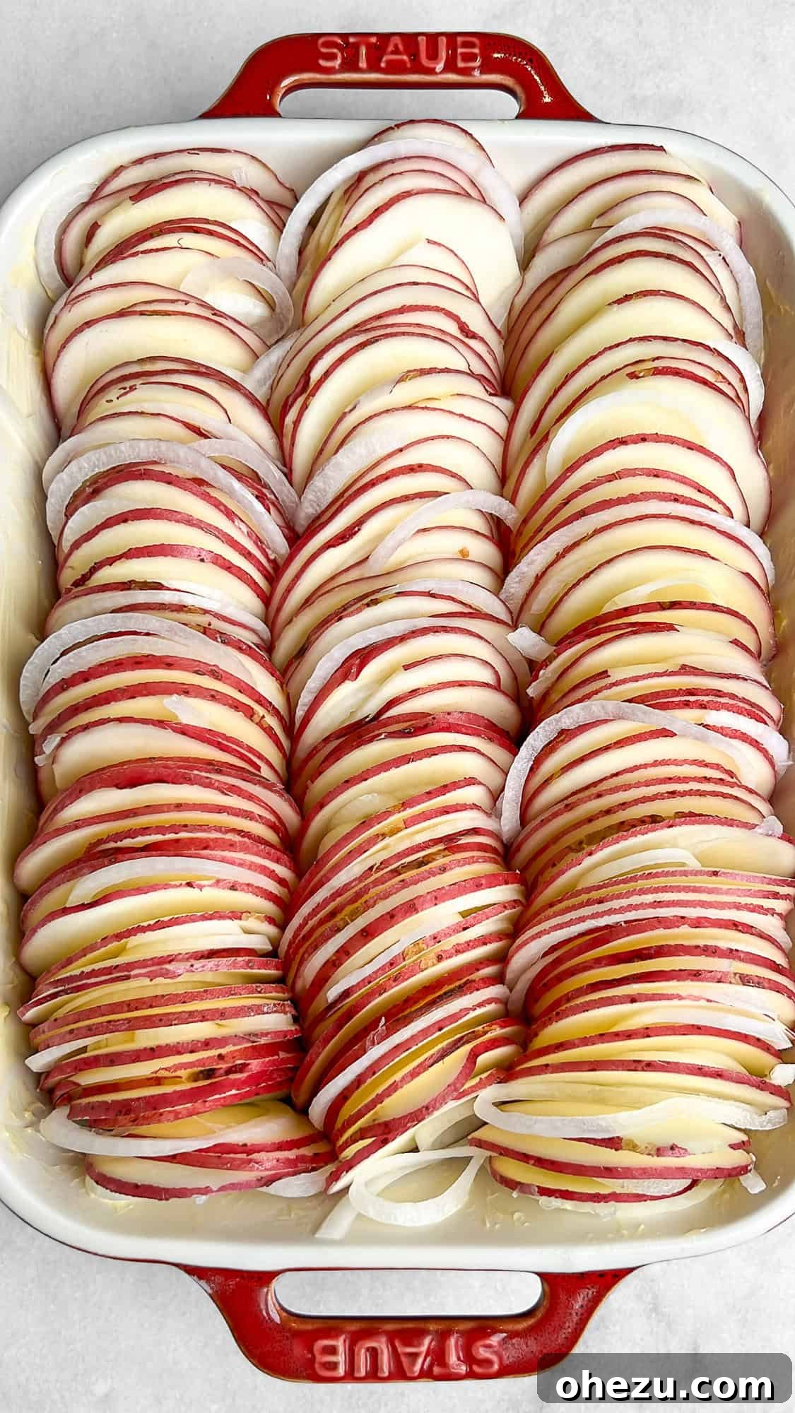 Close-up of neatly arranged potato and onion layers