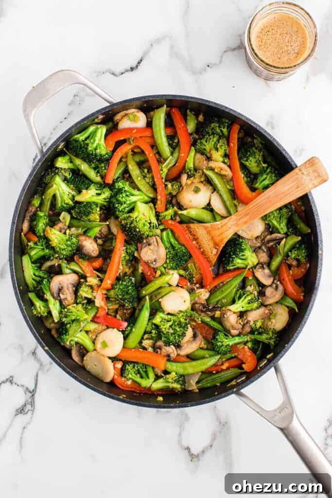 wooden spoon stirring vegetable stir fry
