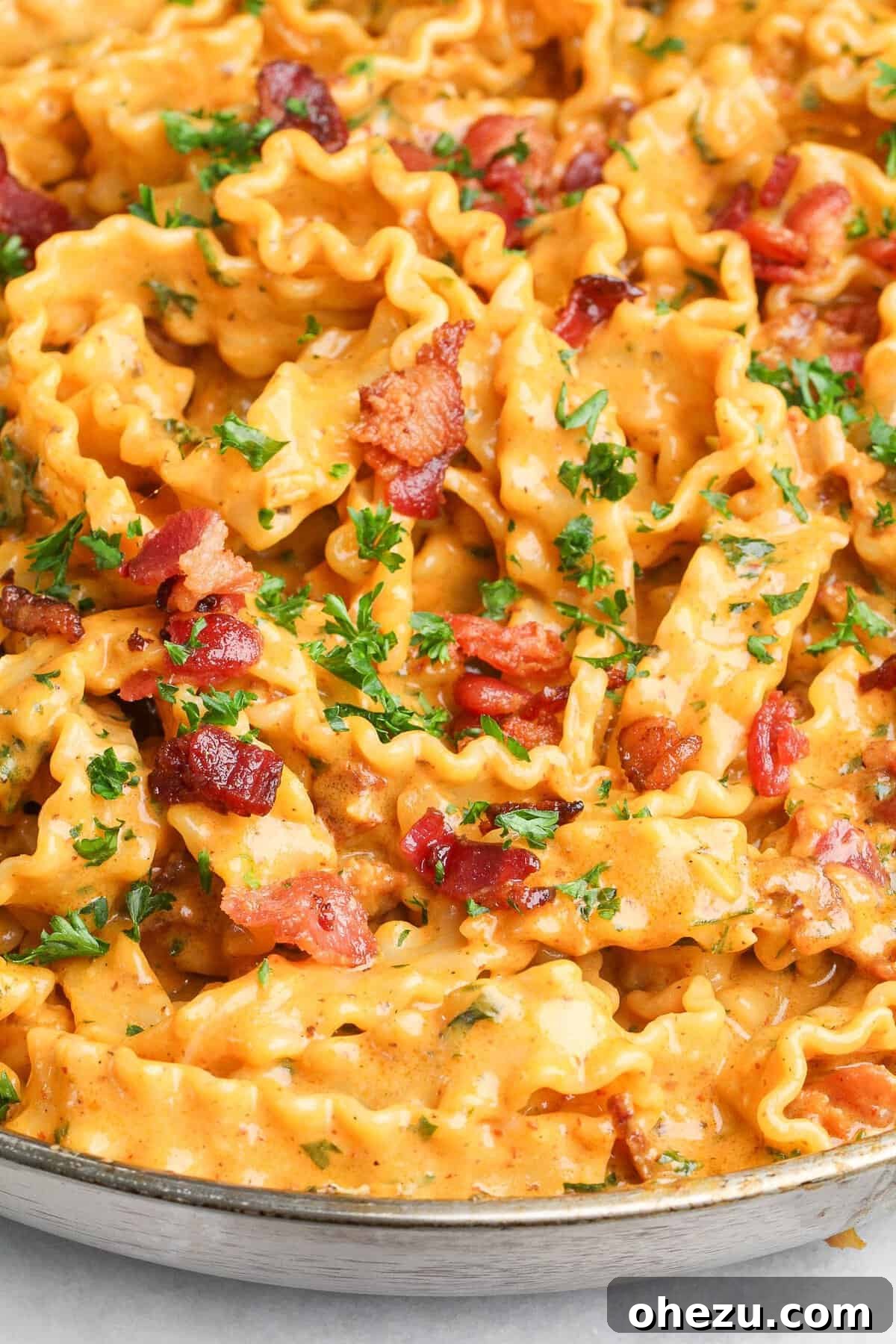 Bold Chipotle Bacon Alfredo 11 A serving of Chipotle Bacon Alfredo pasta garnished with fresh parsley