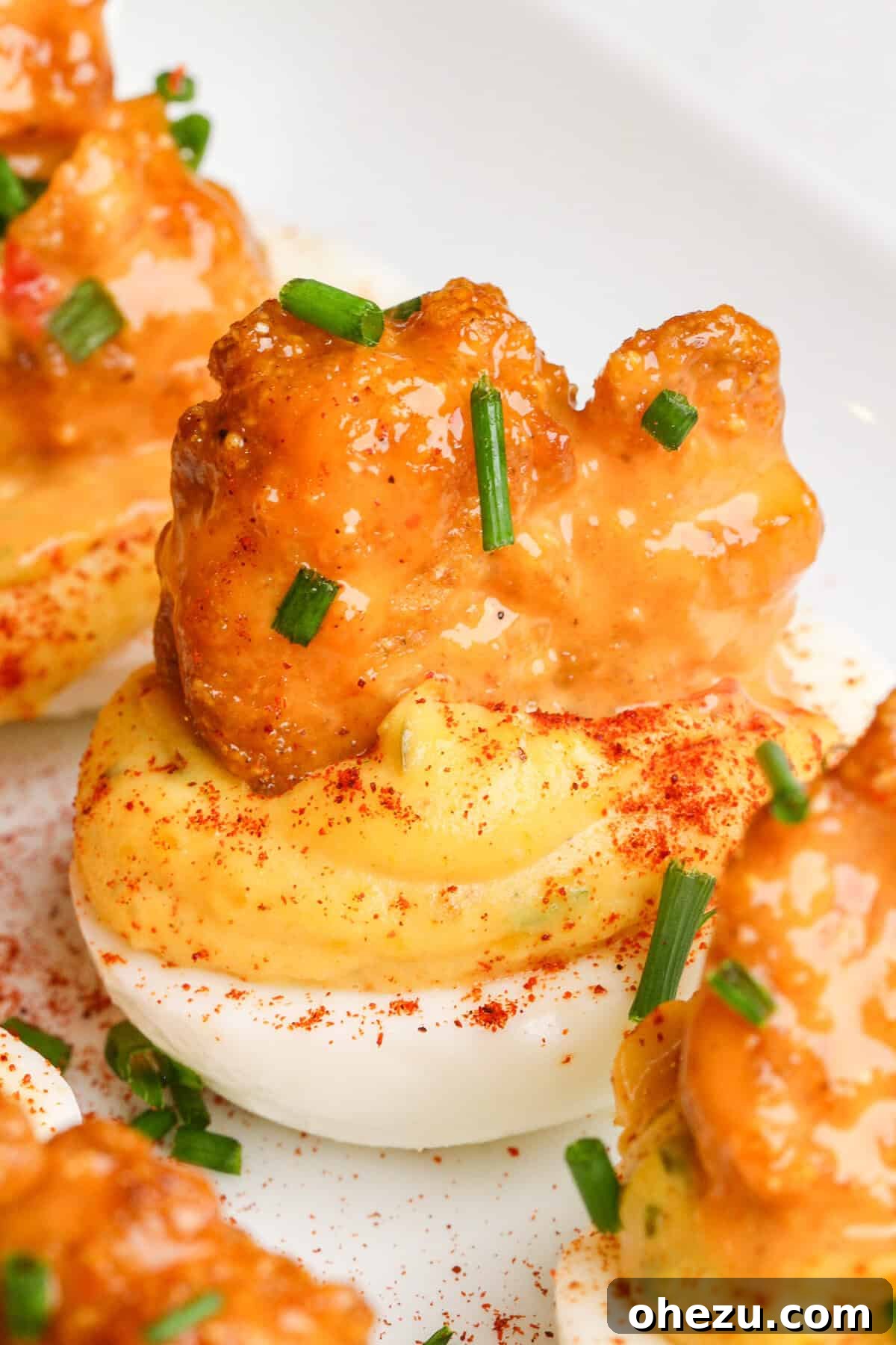 Dynamite Cajun Shrimp Deviled Eggs 2 Firecracker Shrimp Deviled Eggs with crispy fried shrimp and fresh chives, ready to serve as an appetizer