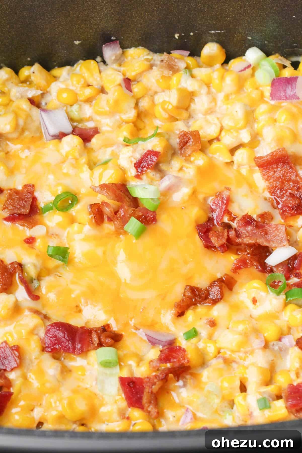 Decadent Slow Cooker Cheesy Creamed Corn 3 Close-up of creamy corn in a slow cooker, showing texture and melted cheese
