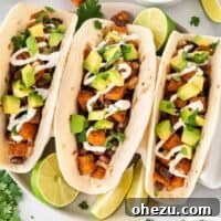 Sweet potato tacos topped with sour cream and diced avocado