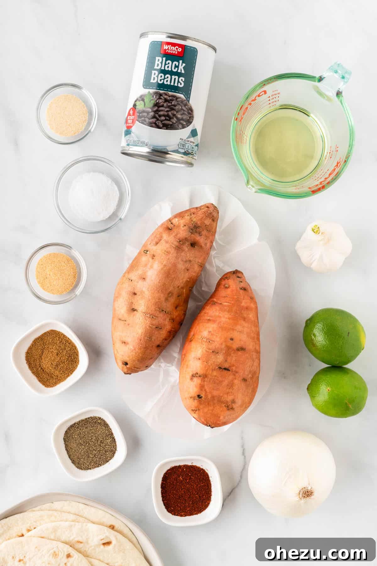 A collection of fresh ingredients laid out for making sweet potato and black bean tacos