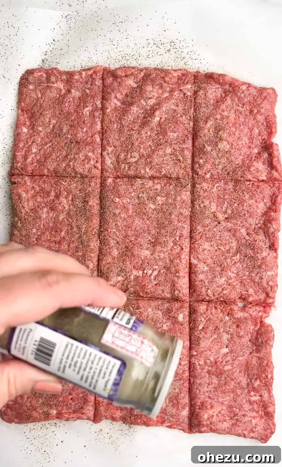 Process shot: Ground beef pressed into a large square, ready to be cut into patties.
