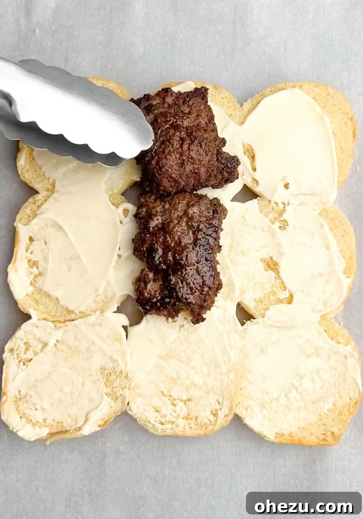 Process shot: Burger patties sizzling in a hot skillet, developing a delicious crust.