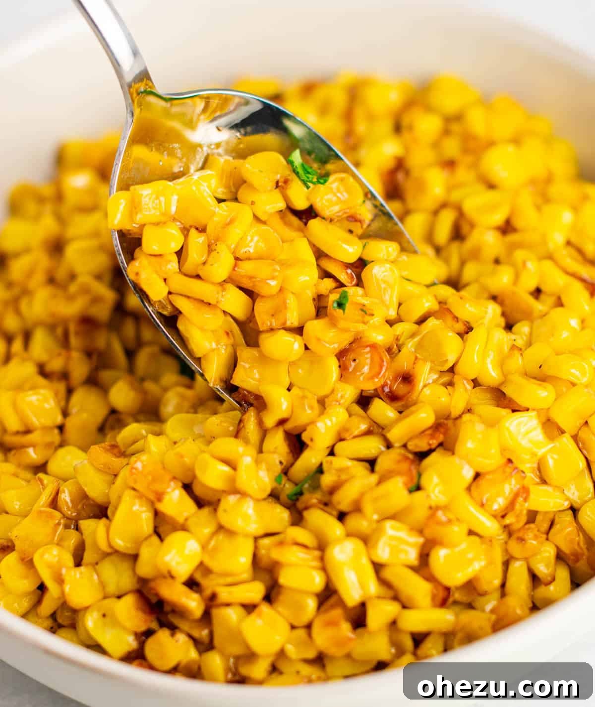 Sizzling Skillet Corn 7 scooping a generous portion of finished skillet corn