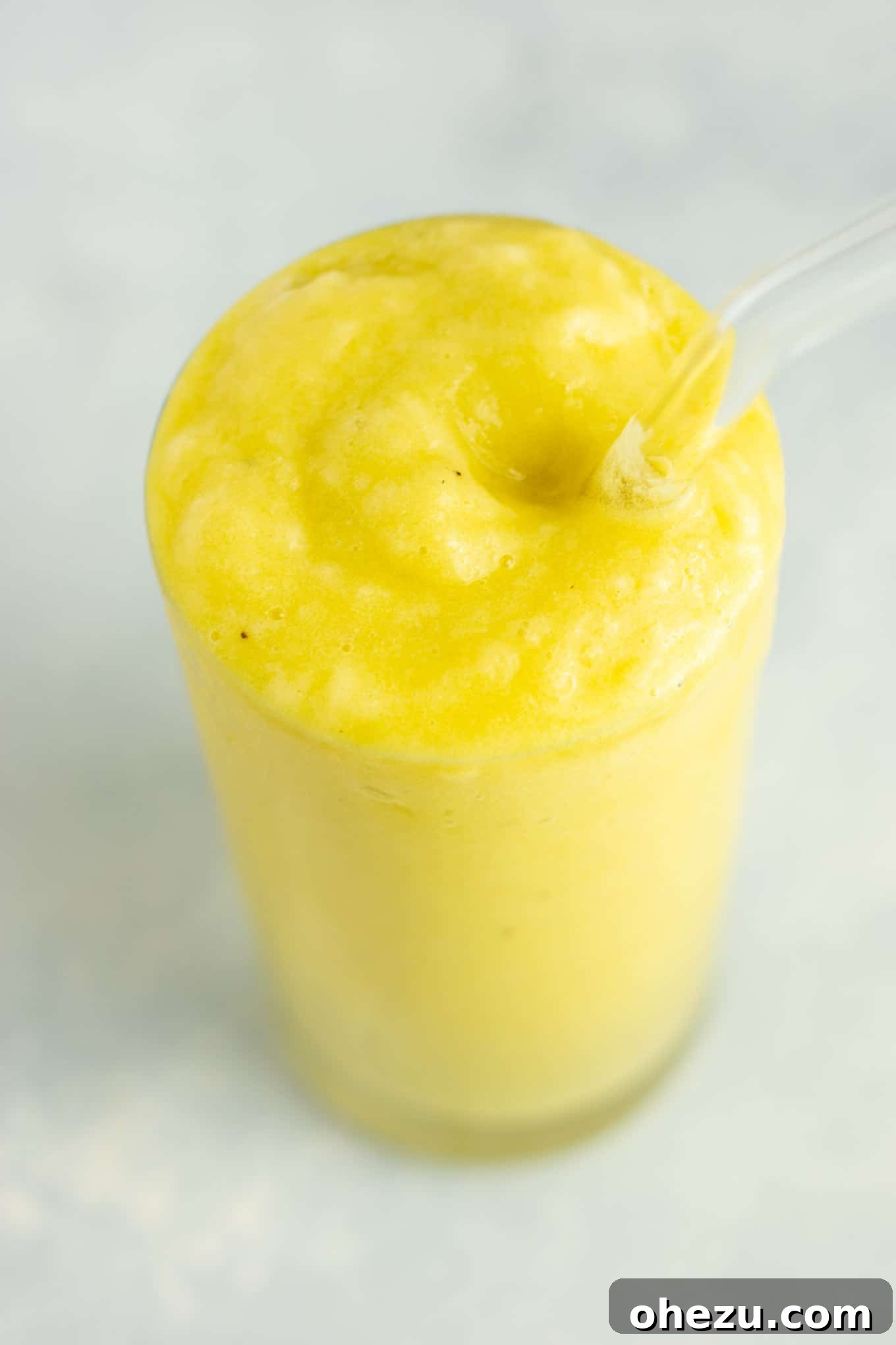 Sunshine Detox Blend 14 A close-up, top-down view of a glass of pineapple detox smoothie, showing its vibrant color and smooth texture.