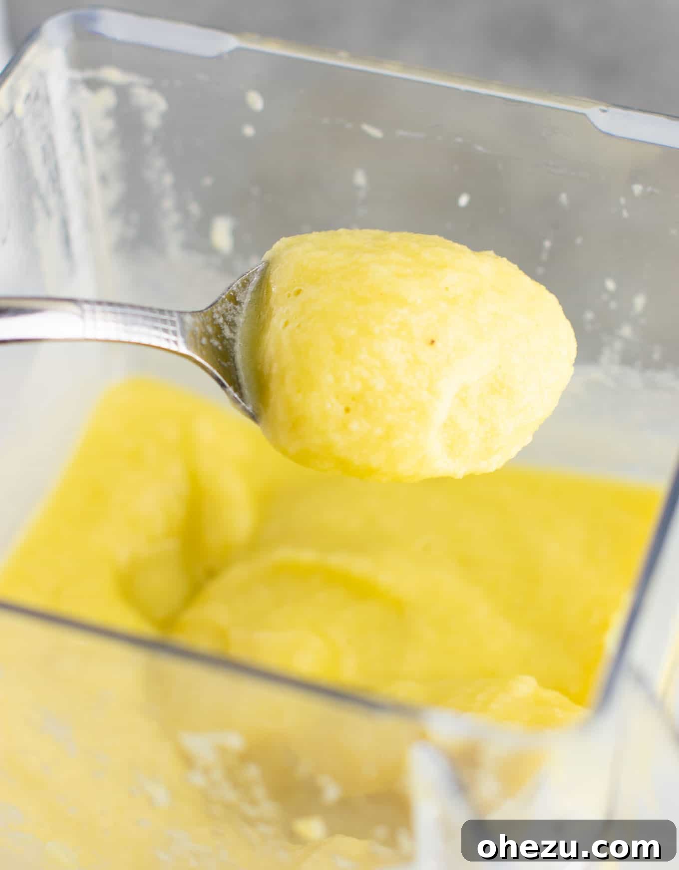 Sunshine Detox Blend 7 A close-up shot of the pineapple detox smoothie on a spoon, highlighting its incredibly thick, almost ice-cream like consistency.