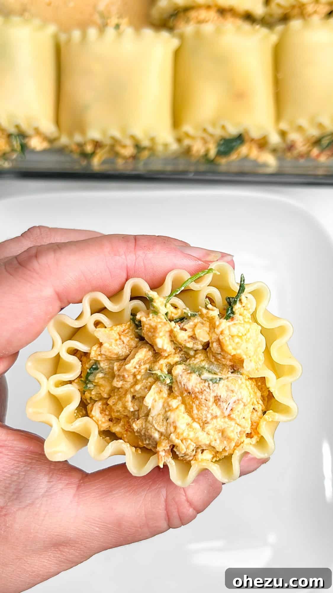 Baking dish almost full with assembled Cajun Chicken Lasagna Roll-ups