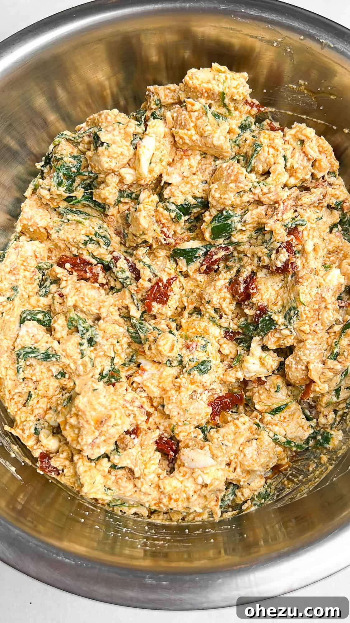 Mixing the creamy cheese and chicken filling for lasagna roll-ups