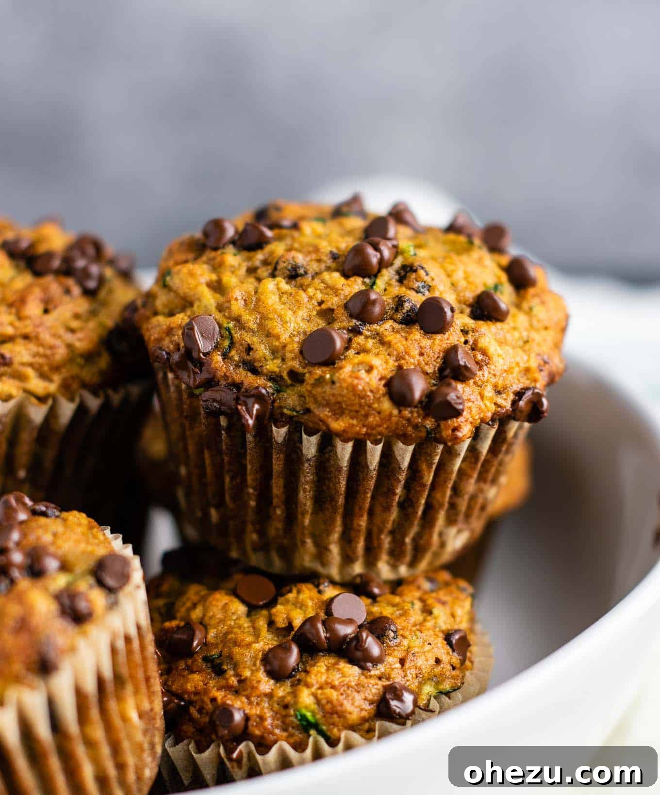 A collection of healthy zucchini chocolate chip muffins arranged artistically on a light surface, ready to be enjoyed.