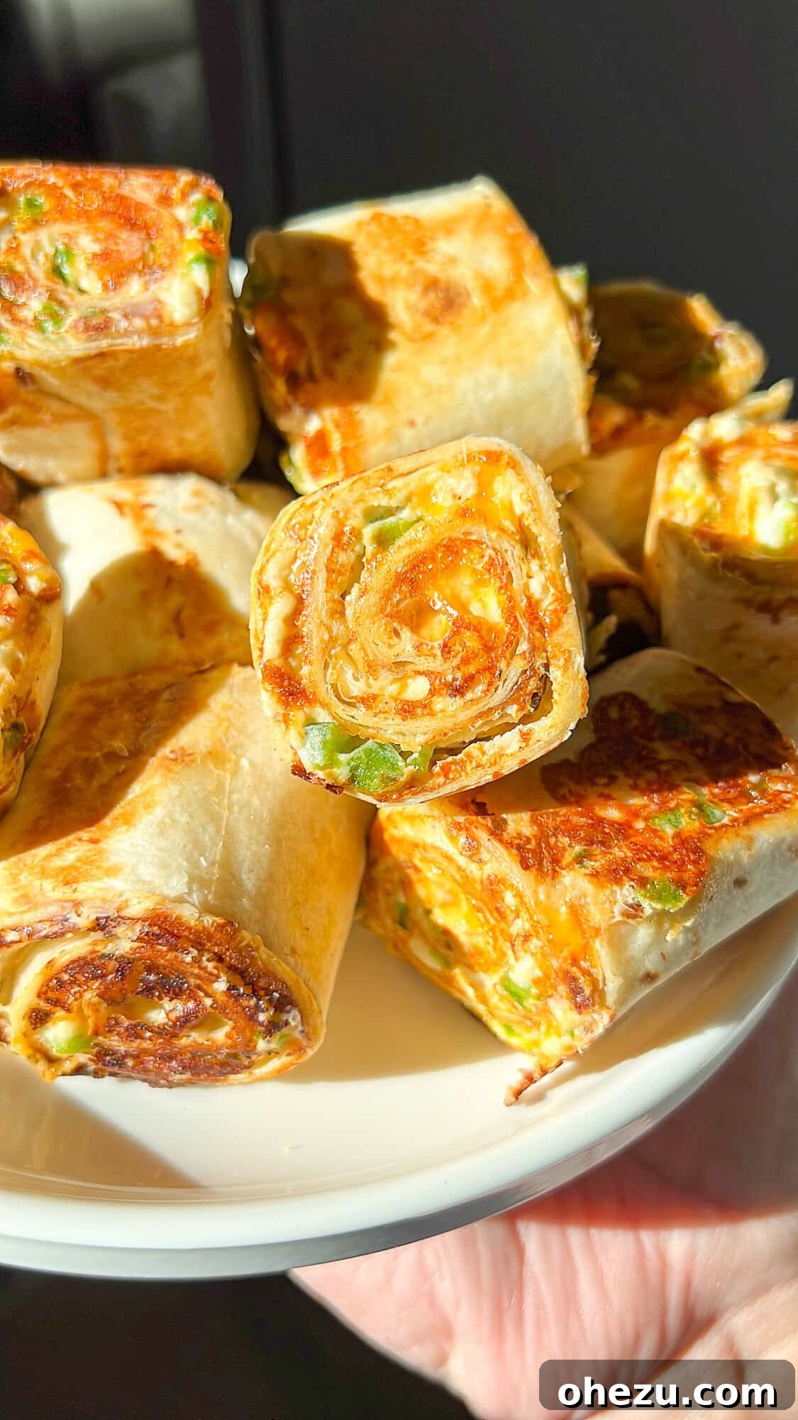 Crispy golden Jalapeno Popper Toasted Pinwheel Sandwiches arranged on a serving platter