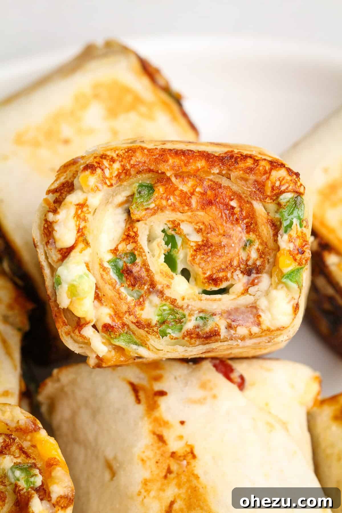 Toasted pinwheel sandwiches with melted cheese, ready to be served