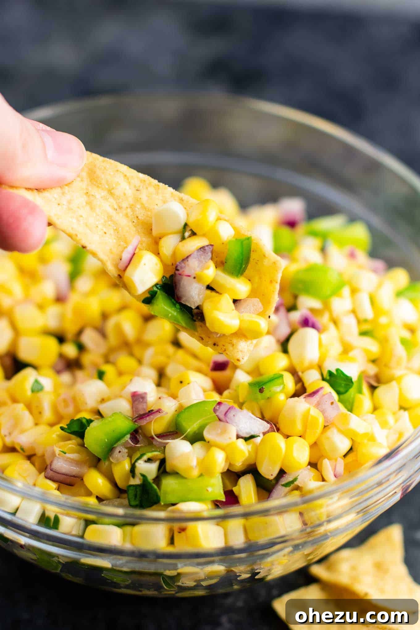 Fresh corn salsa in a glass bowl, showcasing the beautiful mix of ingredients and ready to be enjoyed as a side or topping.
