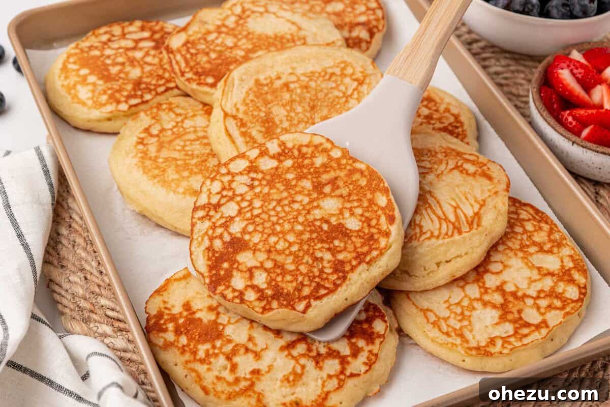 Freshly cooked Greek yogurt pancakes stacked high on a plate, ready to be served.