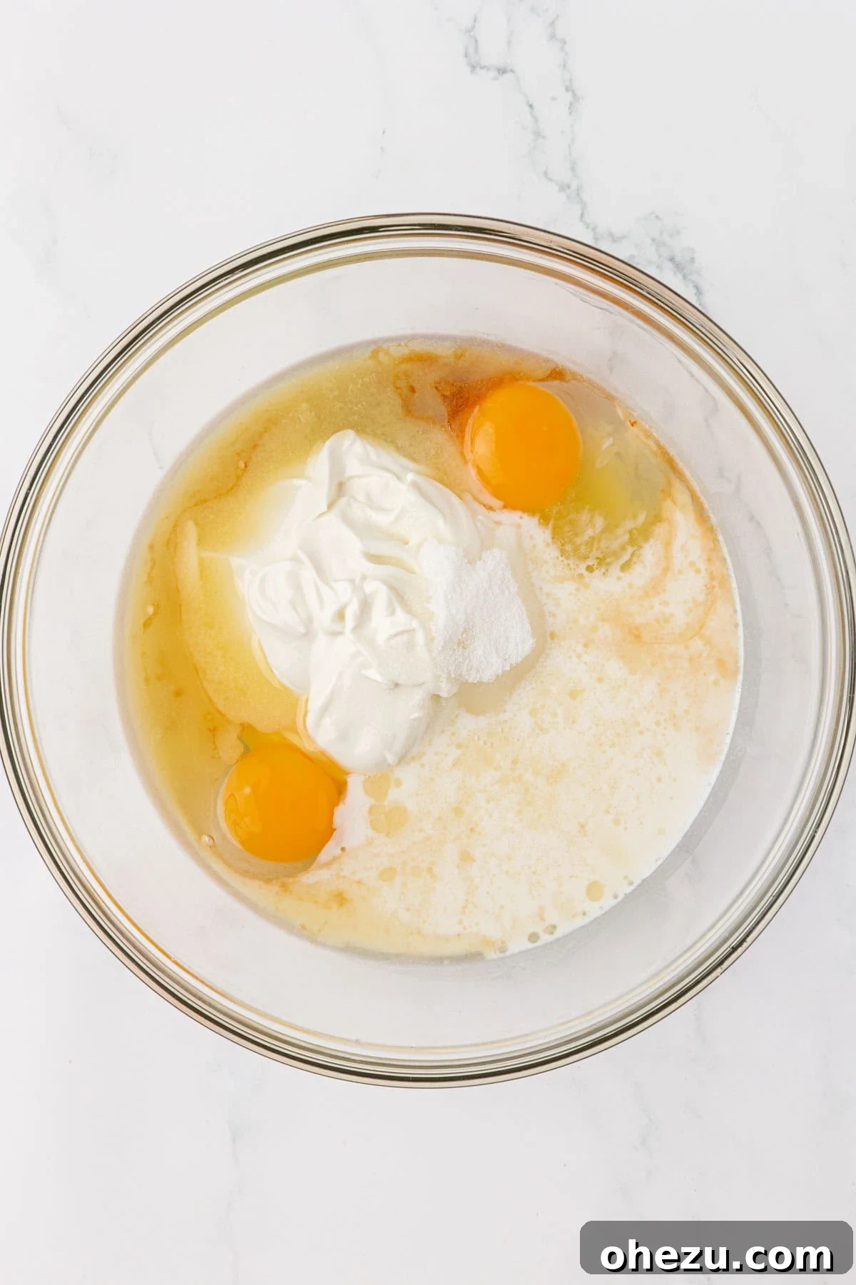 Wet ingredients (yogurt, milk, eggs, butter, sugar, vanilla) in a separate mixing bowl.