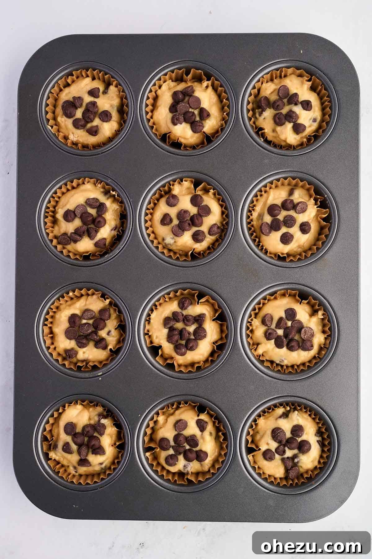 Moist Banana Greek Yogurt Muffins 13 Muffin batter scooped into a lined muffin tin, ready for baking.