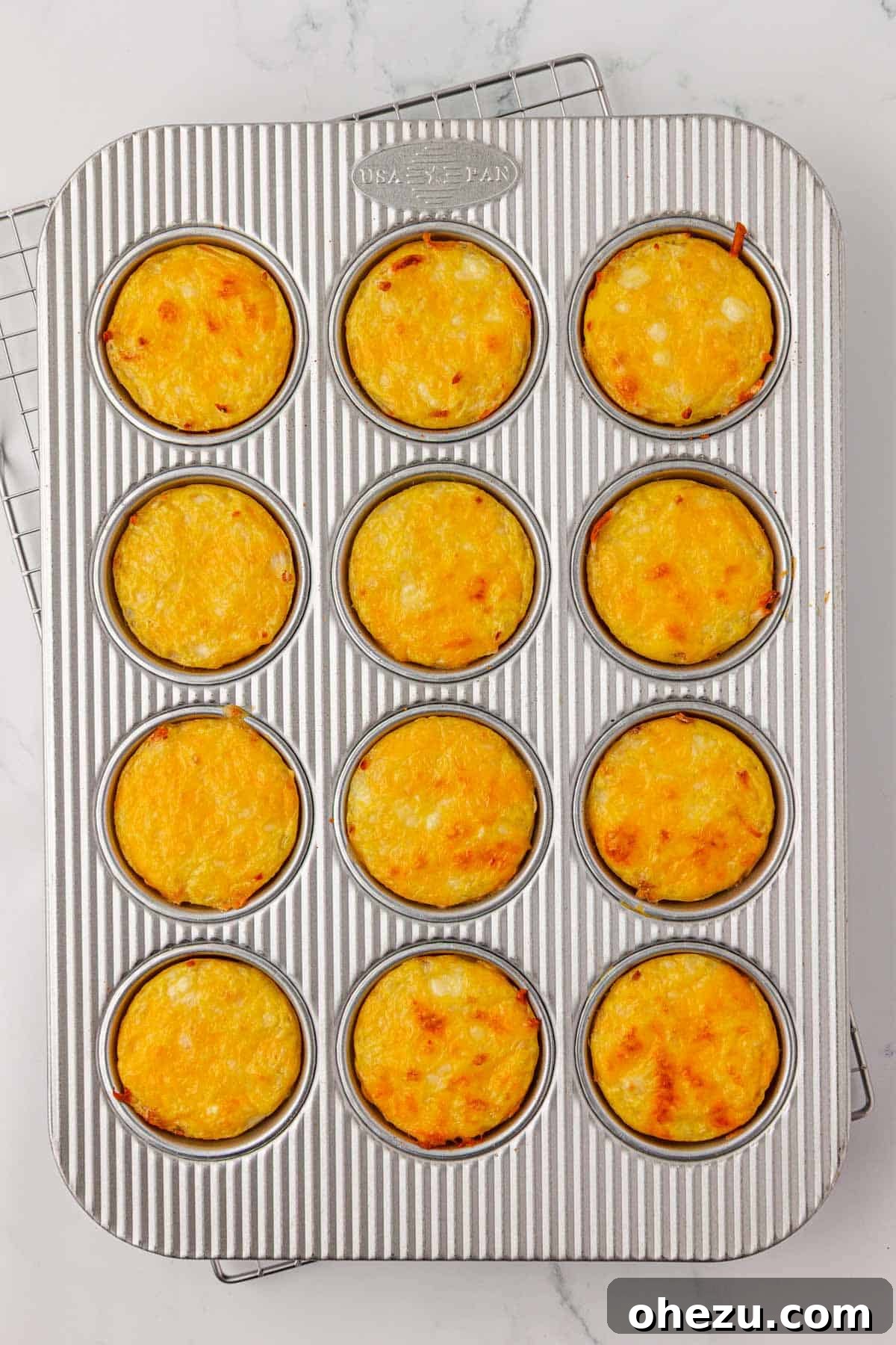 perfectly baked hash brown egg cups in the muffin tin, golden and set