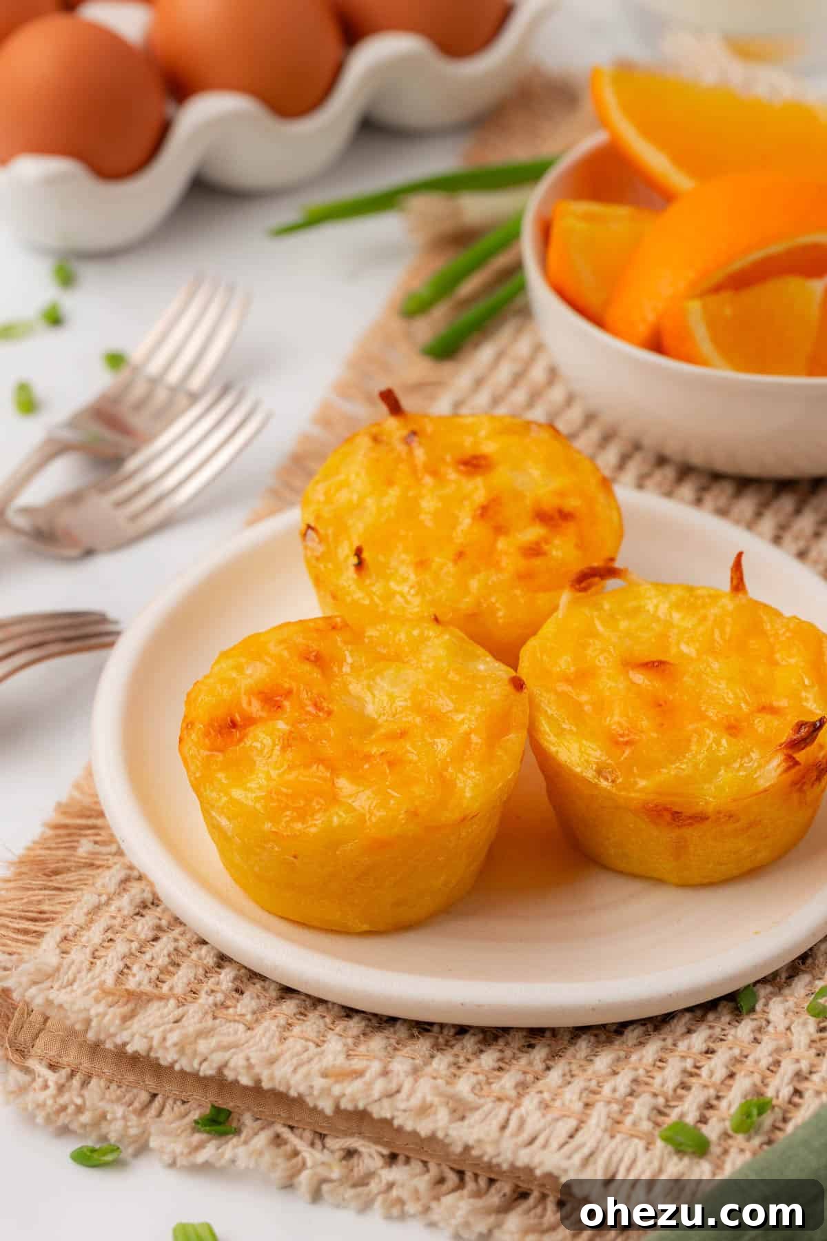 three hash brown egg cups stacked on a plate, highlighting their appetizing appeal