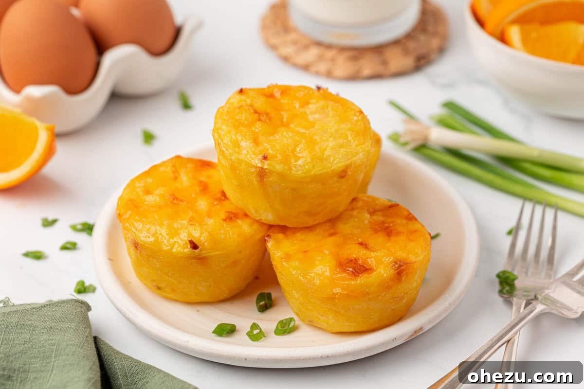 hash brown egg cups served on a white plate with a fork, ready to eat