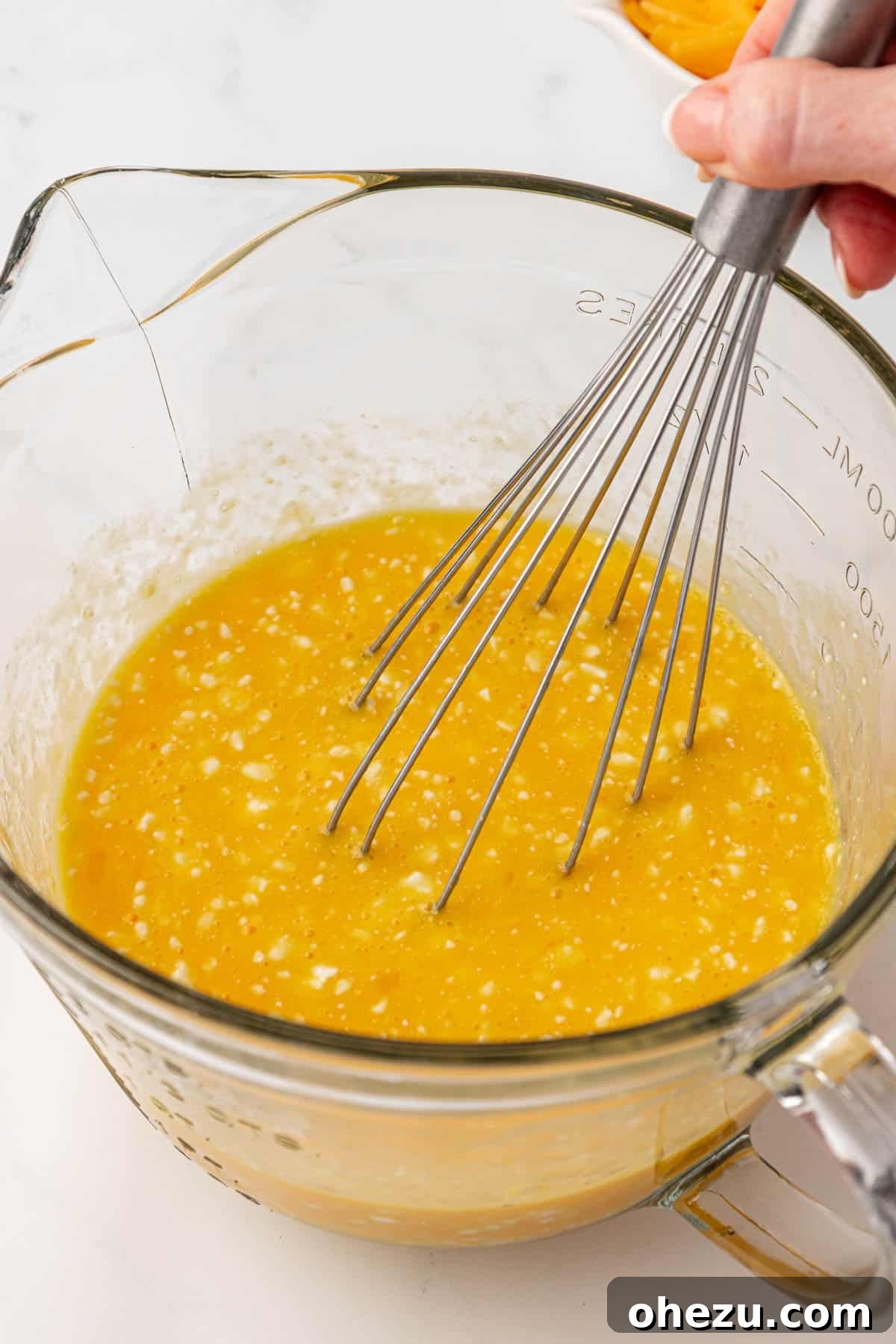 whisking eggs and cottage cheese together until smooth