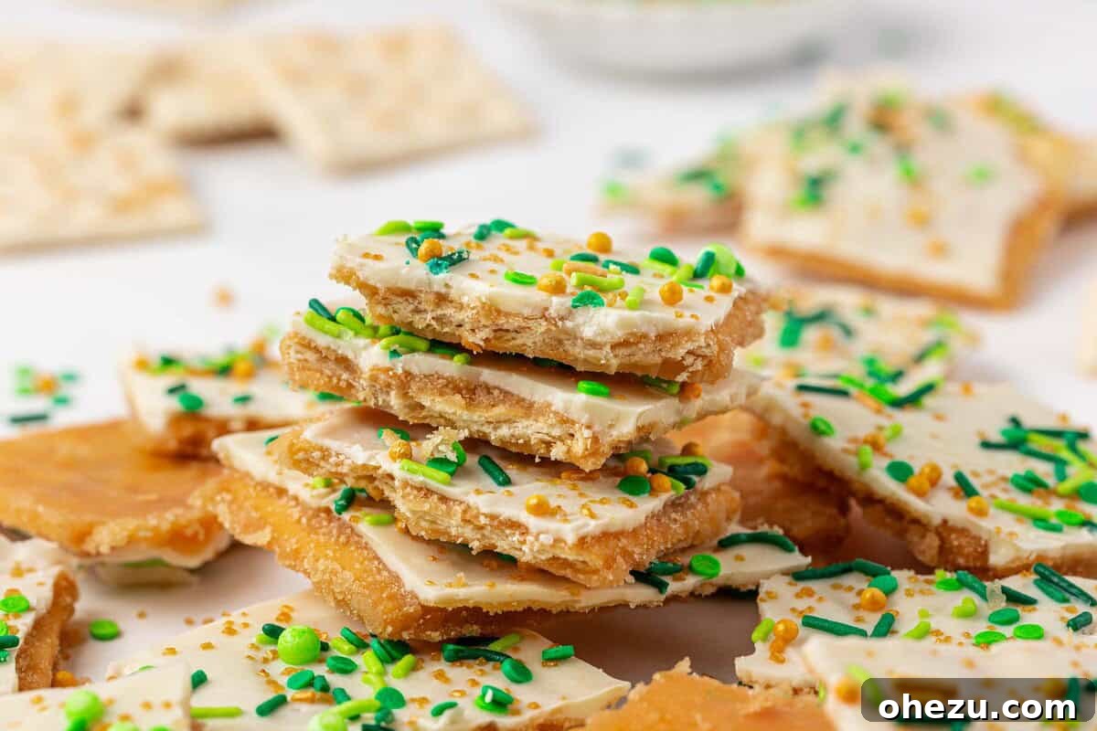 A child's hands decorating Leprechaun crack with green and gold sprinkles, showcasing the fun and family-friendly aspect of the recipe.