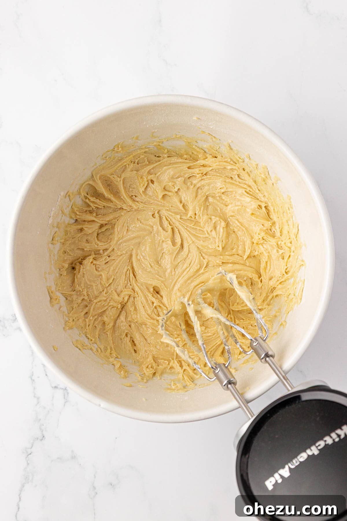 The cake mix batter after being mixed, showing its thick consistency.