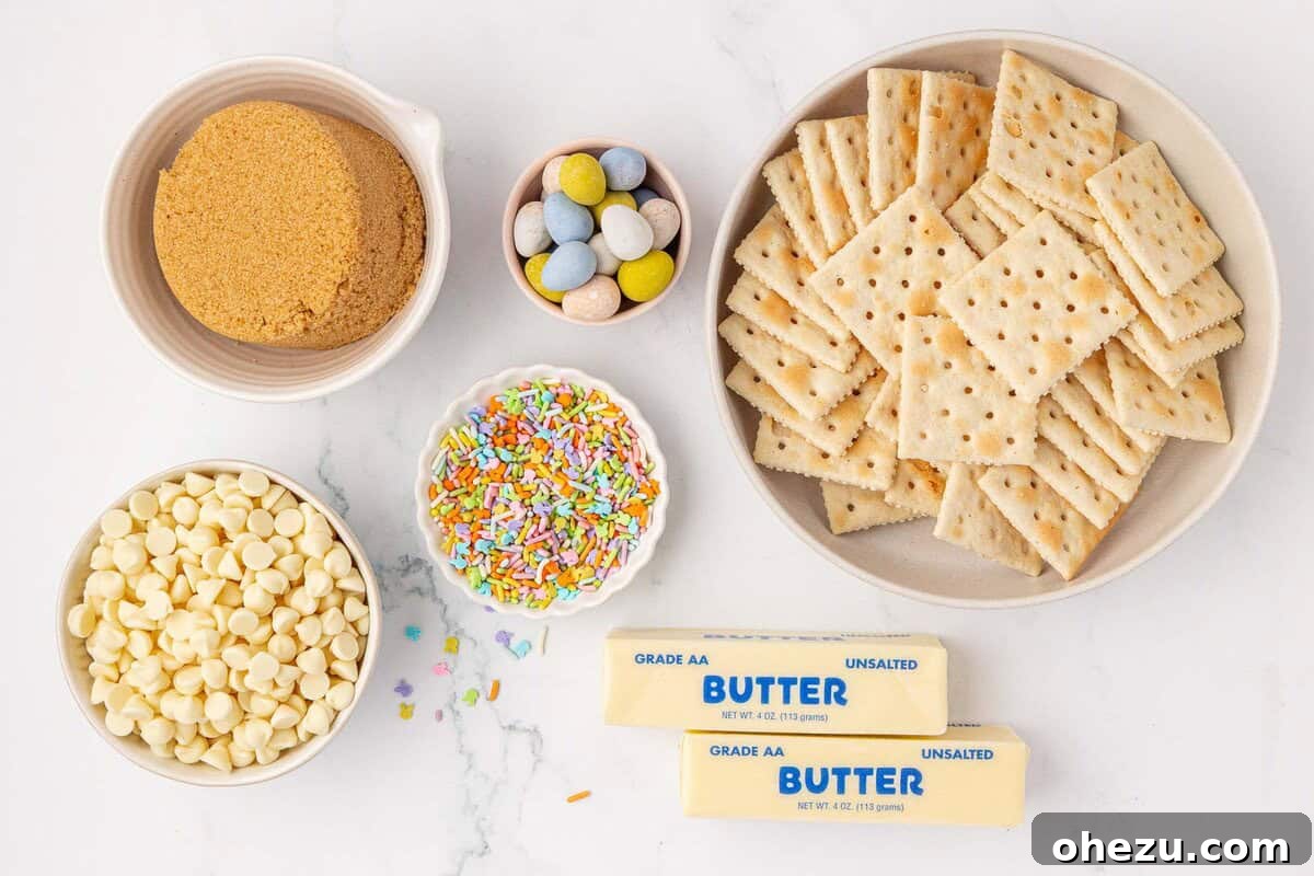 Organized display of Easter Crack ingredients: brown sugar, white chocolate chips, sprinkles, Cadbury Mini Eggs, butter, and saltine crackers laid out on a surface