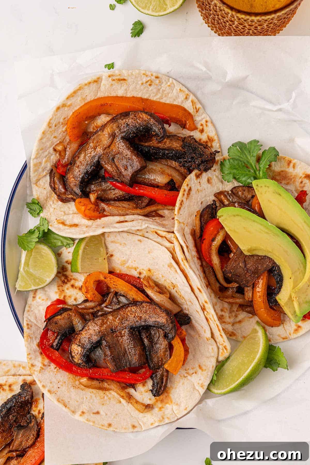Smoky Portobello Fajita Sizzle 3 Close-up of cooked portobello mushroom fajitas in a pan, showcasing their caramelized edges
